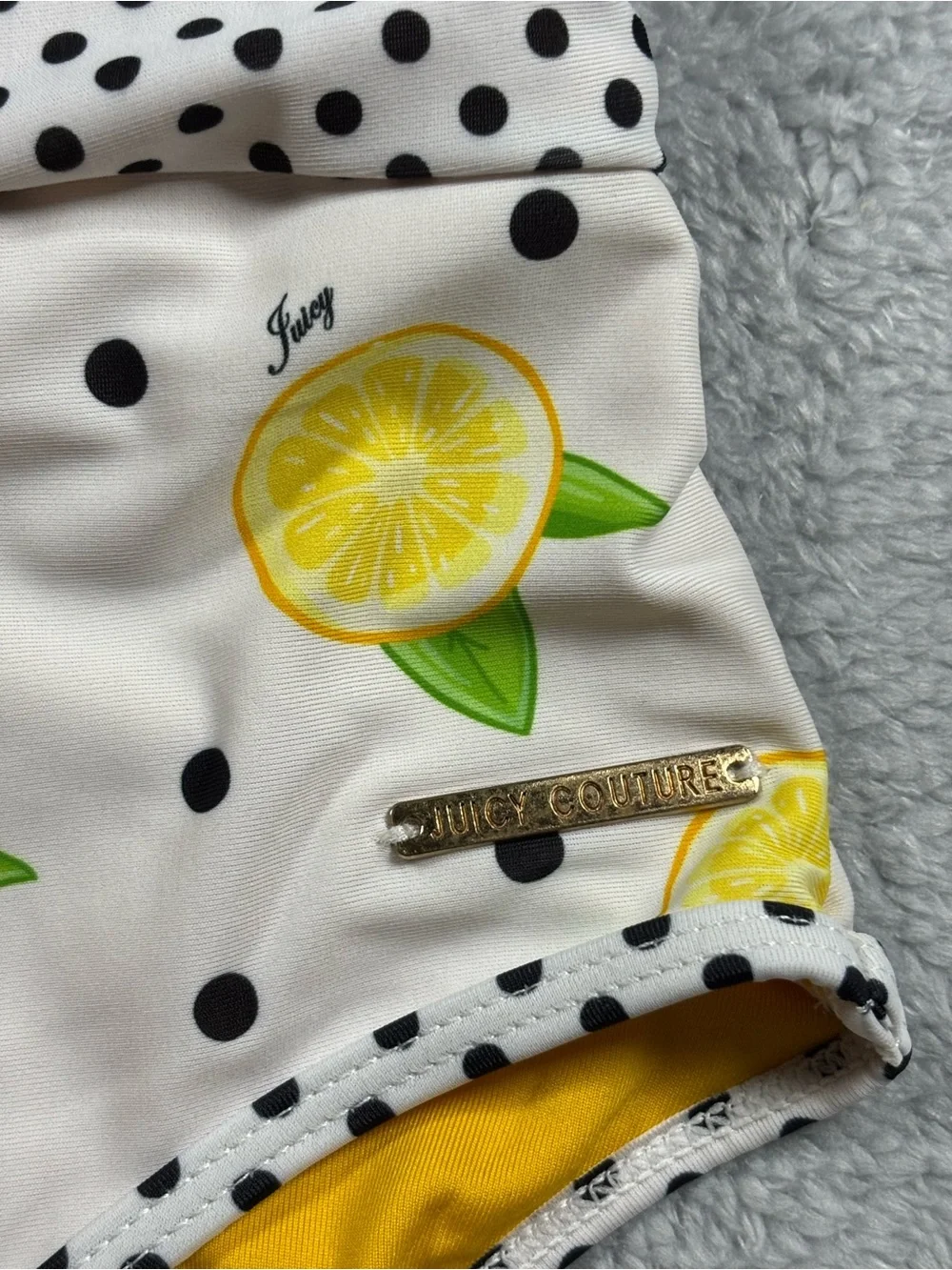 Juicy Couture yellow and white polka dot one piece swimsuit.